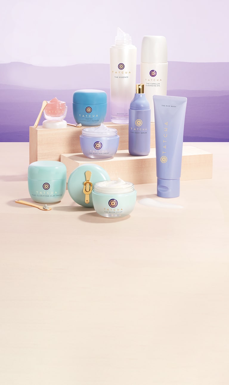 Tatcha products on purple hue horizon over tan wood